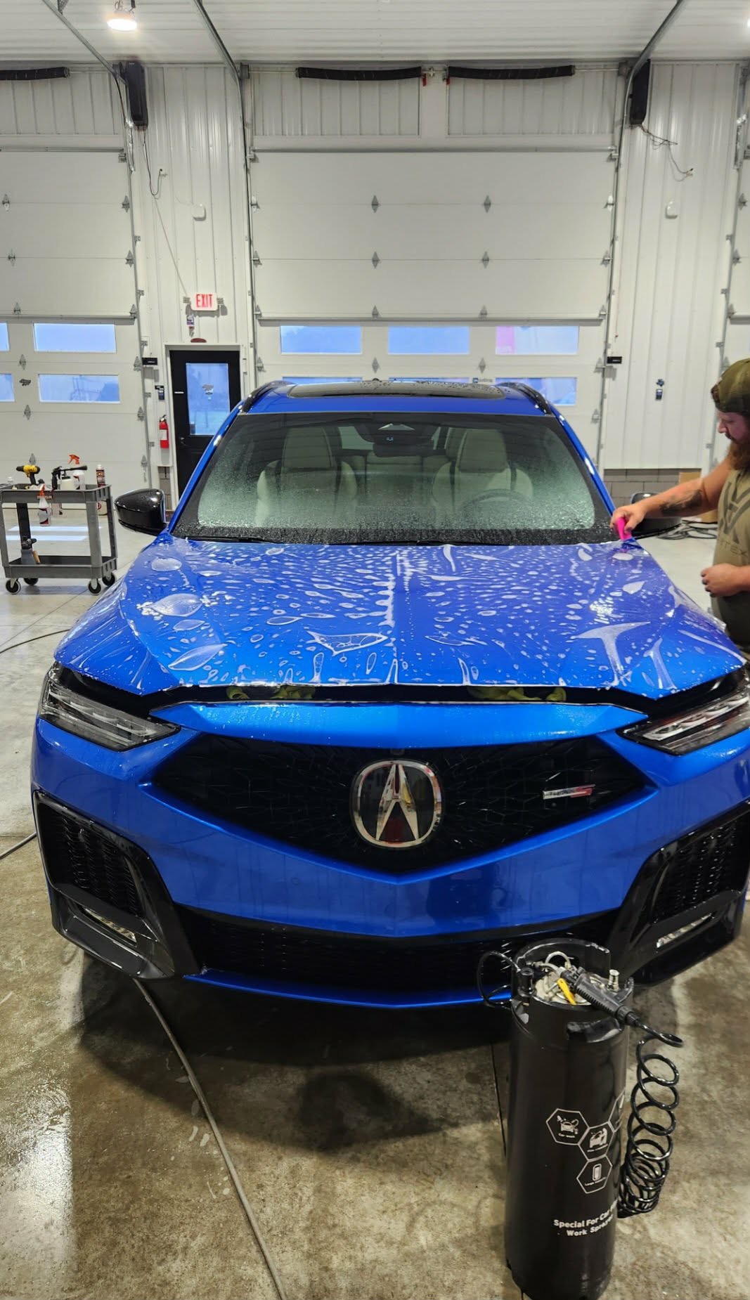 Blue Acura MDX Type S during a hand wash